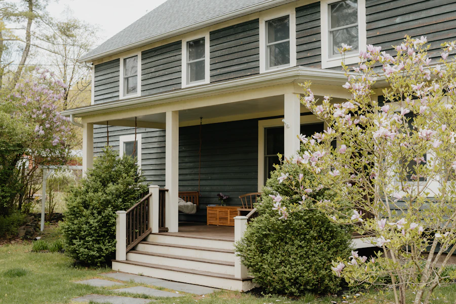 Covered front porch with white columns on a two-storey house